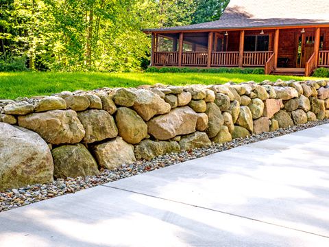 Boulder retaining wall by SereneScapes